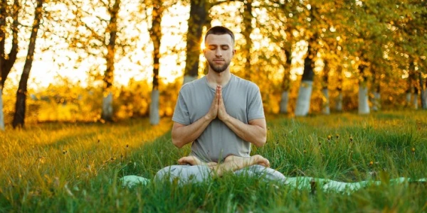 peaceful meditation scene with a man surrounded by greenery
